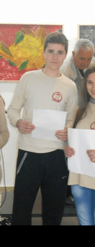 A young Martin holding his writing at an event